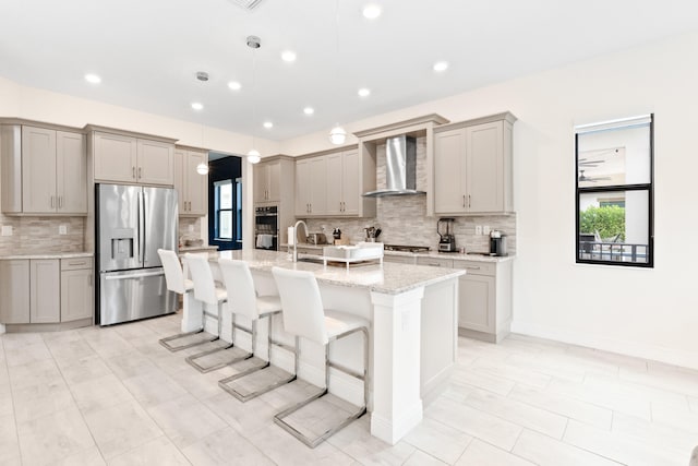8640 E Baypoint Cir, Parkland, FL 33076 - kitchen with stainless steel appliances, wall chimney range hood, gray cabinets, healthy amount of natural light, and recessed lighting