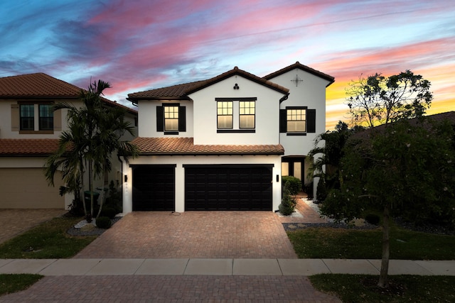8640 E Baypoint Cir, Parkland, FL 33076 - mediterranean / spanish home featuring an attached garage, stucco siding, decorative driveway, and a tiled roof