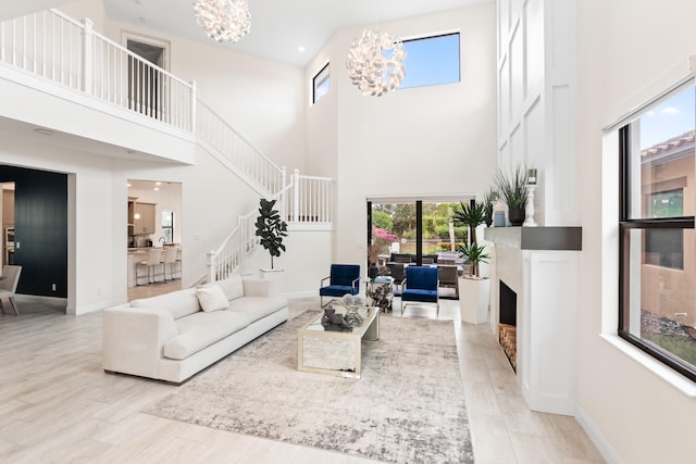 8640 E Baypoint Cir, Parkland, FL 33076 - living room featuring a chandelier, a towering ceiling, stairway, healthy amount of natural light, and a fireplace
