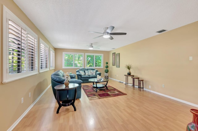 1420 NW 27th Ave, Delray Beach, FL 33445 - living area featuring wood finished floors, a textured ceiling, a ceiling fan, and baseboards