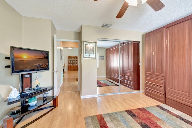 1420 NW 27th Ave, Delray Beach, FL 33445 - bedroom with a textured ceiling, light wood finished floors, ceiling fan, a closet, and baseboards