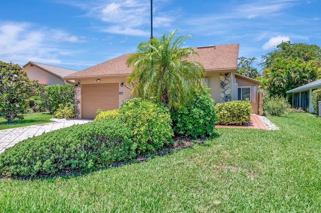 1420 NW 27th Ave, Delray Beach, FL 33445 - view of front of home with an attached garage, stucco siding, concrete driveway, and a front lawn