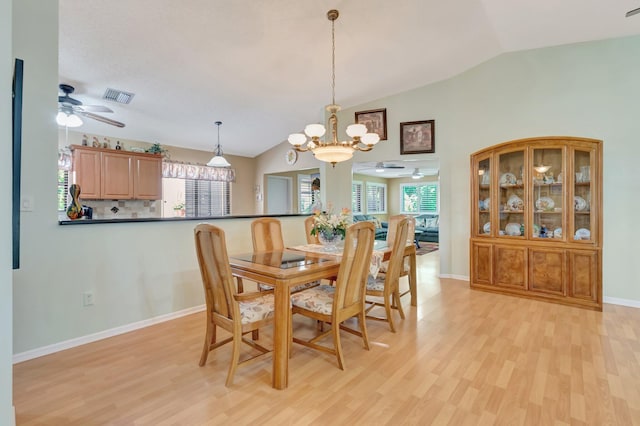1420 NW 27th Ave, Delray Beach, FL 33445 - dining area with a ceiling fan, vaulted ceiling, light wood finished floors, plenty of natural light, and a chandelier