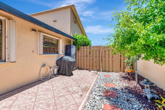 1420 NW 27th Ave, Delray Beach, FL 33445 - view of patio featuring fence and a grill