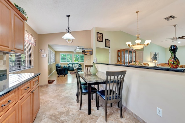 1420 NW 27th Ave, Delray Beach, FL 33445 - dining area with lofted ceiling, ceiling fan, a chandelier, and light tile patterned flooring
