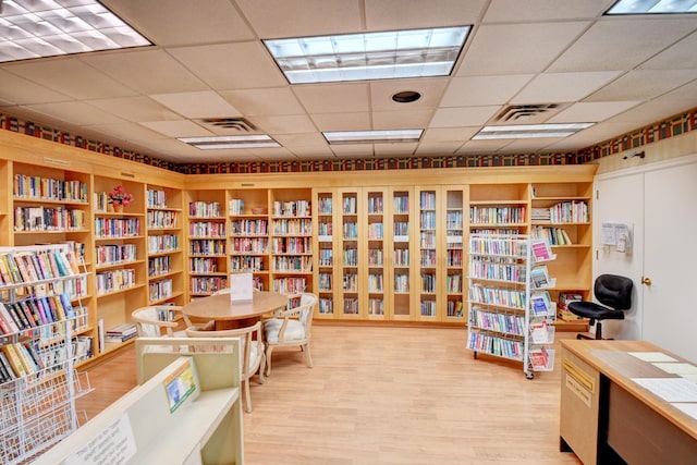 1420 NW 27th Ave, Delray Beach, FL 33445 - home office featuring bookshelves, a drop ceiling, and light wood-style floors