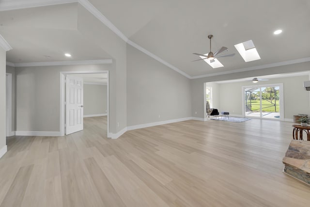 unfurnished living room featuring lofted ceiling, light wood finished floors, a skylight, a ceiling fan, and baseboards