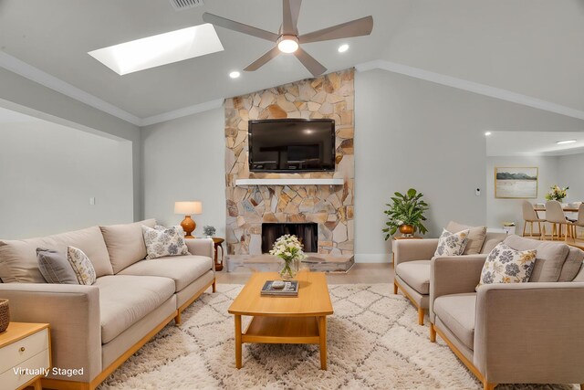 4365 SW Bimini Cir S, Palm City, FL 34990 - living room with a fireplace, a ceiling fan, wood finished floors, crown molding, and a skylight