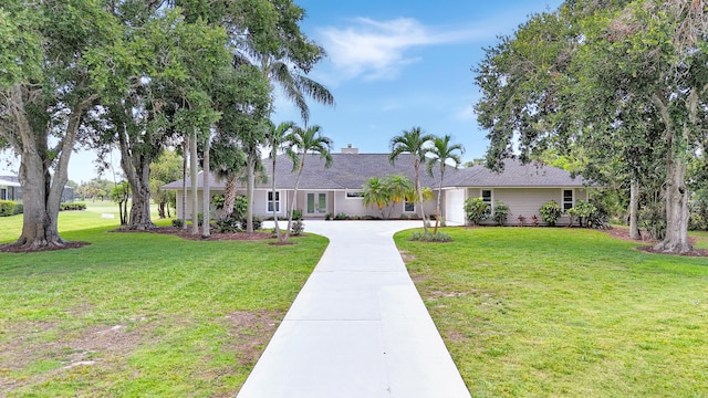 single story home with driveway and a front yard