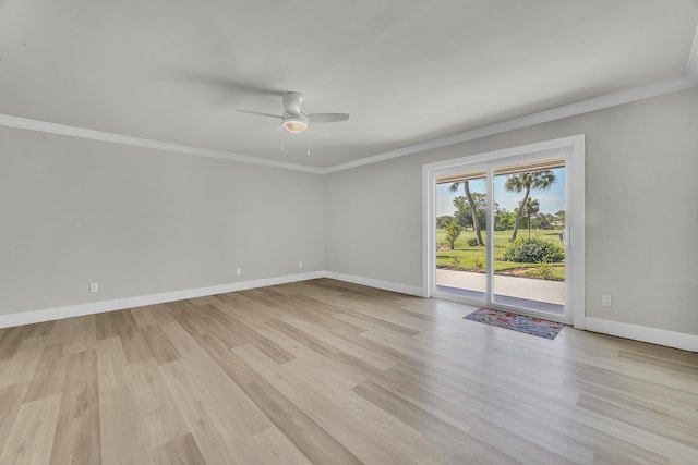 spare room with a ceiling fan, ornamental molding, light wood-style flooring, and baseboards