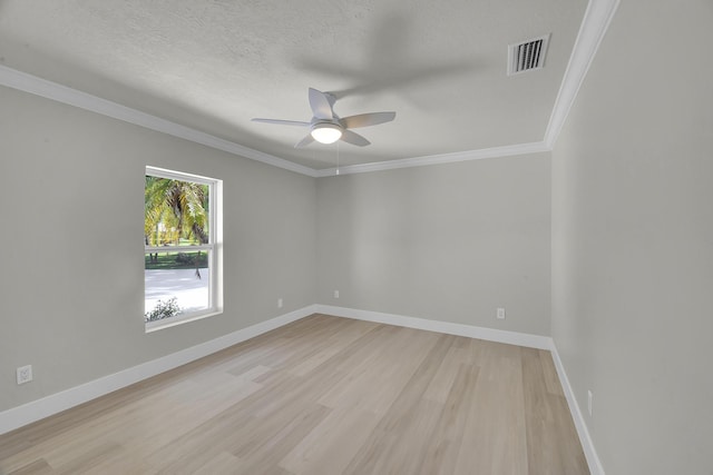 empty room featuring light wood finished floors, ceiling fan, crown molding, baseboards, and a textured ceiling