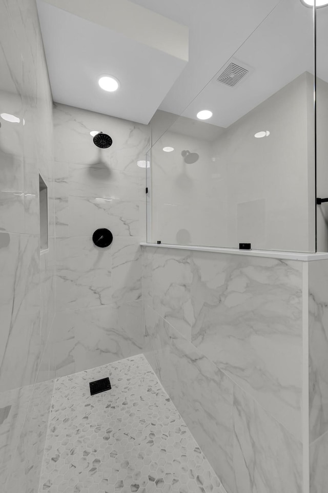 full bath with a marble finish shower