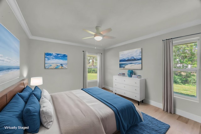 4365 SW Bimini Cir S, Palm City, FL 34990 - bedroom with light wood-style flooring, crown molding, baseboards, a ceiling fan, and a water view
