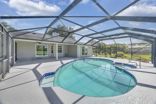 outdoor pool with a patio, a jacuzzi, ceiling fan, and glass enclosure