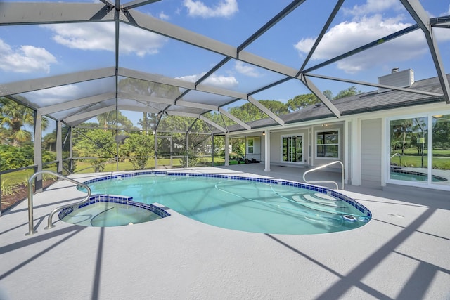 view of pool featuring a patio, a pool with connected hot tub, and glass enclosure