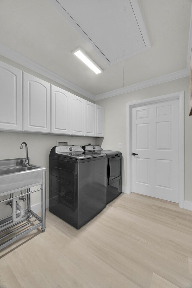 4365 SW Bimini Cir S, Palm City, FL 34990 - laundry room featuring attic access, cabinet space, independent washer and dryer, light wood-style flooring, and ornamental molding