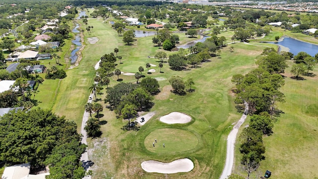 aerial view of property and surrounding area with a large body of water, a golf club, and nearby suburban area