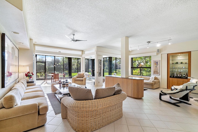 17652 Ashbourne D Way Unit D, Boca Raton, FL 33496 - living area featuring light tile patterned floors, ceiling fan, a textured ceiling, and rail lighting