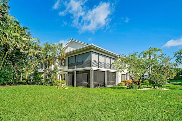 17652 Ashbourne D Way Unit D, Boca Raton, FL 33496 - rear view of property featuring a sunroom and a lawn