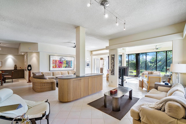 17652 Ashbourne D Way Unit D, Boca Raton, FL 33496 - living area featuring ceiling fan, light tile patterned floors, and a textured ceiling
