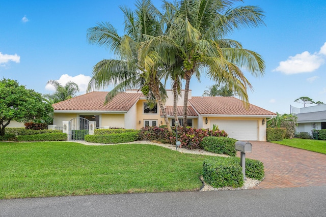 4877 Pineview Cir, Delray Beach, FL 33445 - view of front of house featuring stucco siding, decorative driveway, a garage, and a front yard