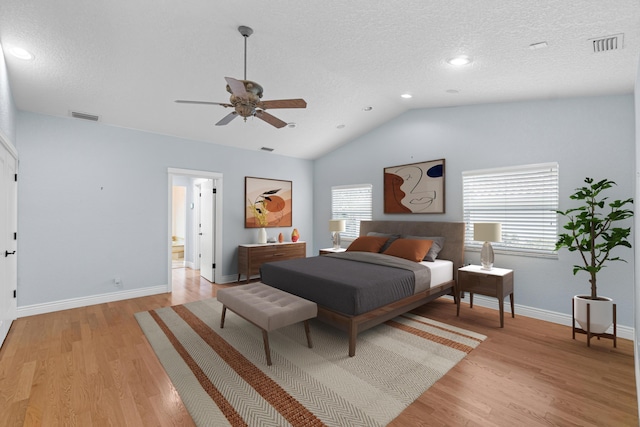 4877 Pineview Cir, Delray Beach, FL 33445 - bedroom featuring multiple windows, baseboards, light wood-style flooring, vaulted ceiling, and a textured ceiling