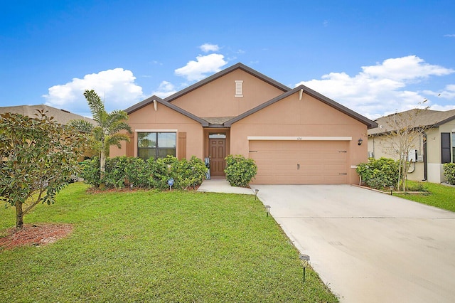6241 NW Regent St, Port Saint Lucie, FL 34983 - view of front of house with a garage, driveway, a front yard, and stucco siding