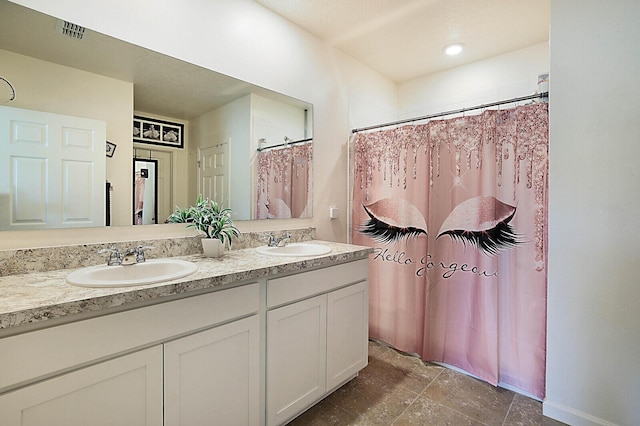 6241 NW Regent St, Port Saint Lucie, FL 34983 - bathroom with double vanity, curtained shower, and stone finish floors