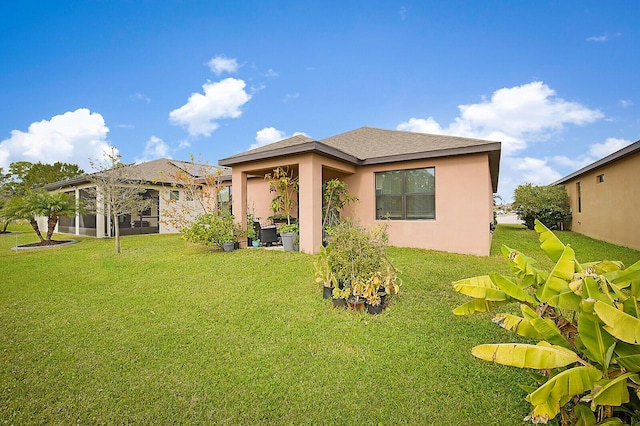6241 NW Regent St, Port Saint Lucie, FL 34983 - rear view of property featuring stucco siding and a lawn