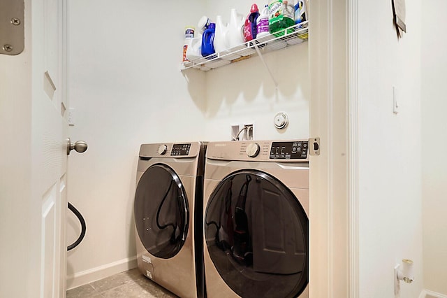 6241 NW Regent St, Port Saint Lucie, FL 34983 - clothes washing area with baseboards, washer and dryer, and light tile patterned flooring
