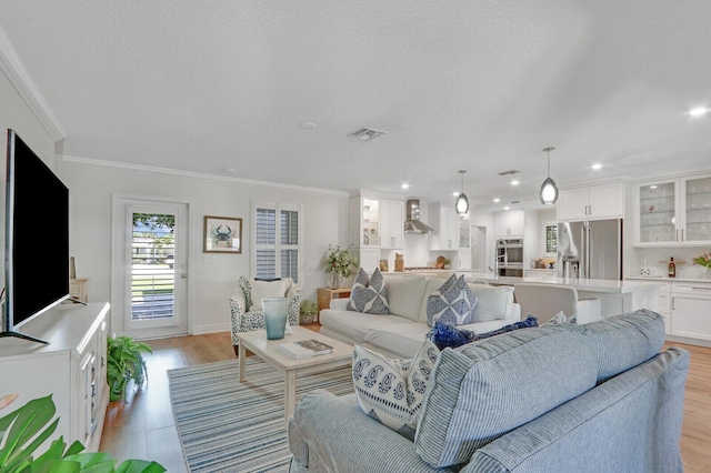 605 Flotilla Ln, North Palm Beach, FL 33408 - living room with light wood finished floors, crown molding, recessed lighting, and baseboards
