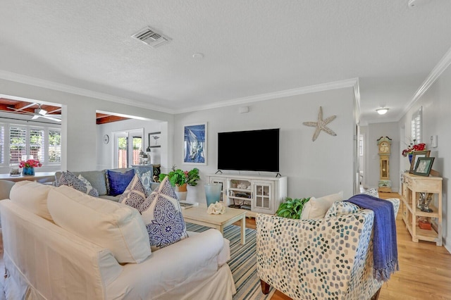 605 Flotilla Ln, North Palm Beach, FL 33408 - living room with crown molding, light wood finished floors, a ceiling fan, and a textured ceiling