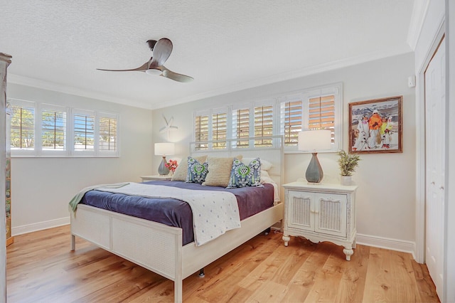 605 Flotilla Ln, North Palm Beach, FL 33408 - bedroom with crown molding, wood finished floors, baseboards, a textured ceiling, and ceiling fan