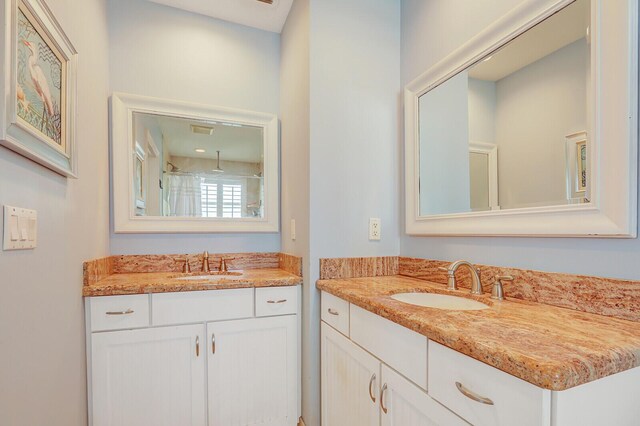 605 Flotilla Ln, North Palm Beach, FL 33408 - full bathroom featuring two vanities and a shower