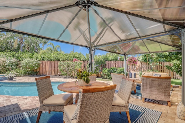 605 Flotilla Ln, North Palm Beach, FL 33408 - view of patio featuring a fenced backyard, a gazebo, and outdoor dining space