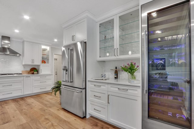 605 Flotilla Ln, North Palm Beach, FL 33408 - kitchen with appliances with stainless steel finishes, wall chimney range hood, light countertops, white cabinets, and recessed lighting