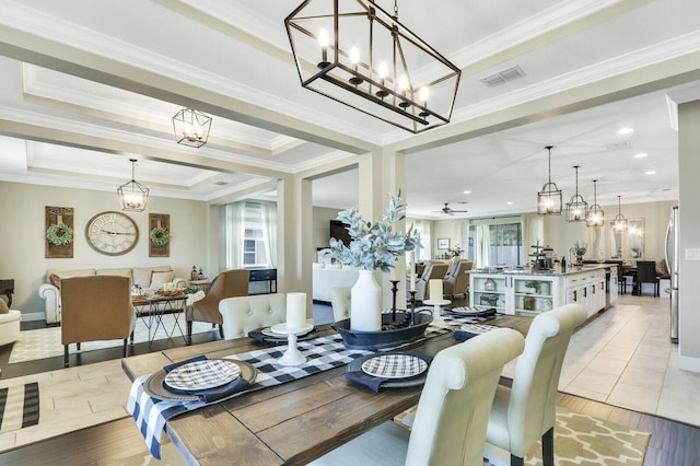 4052 SW Mccandless St, Port Saint Lucie, FL 34953 - dining space featuring light wood-style flooring, a chandelier, ornamental molding, a tray ceiling, and recessed lighting