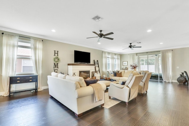 4052 SW Mccandless St, Port Saint Lucie, FL 34953 - living room featuring crown molding, a glass covered fireplace, ceiling fan, recessed lighting, and dark wood finished floors