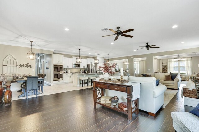 4052 SW Mccandless St, Port Saint Lucie, FL 34953 - living area with ceiling fan, recessed lighting, ornamental molding, and wood finished floors