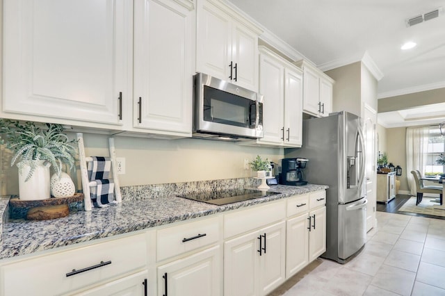 4052 SW Mccandless St, Port Saint Lucie, FL 34953 - kitchen featuring appliances with stainless steel finishes, ornamental molding, white cabinetry, light stone counters, and recessed lighting
