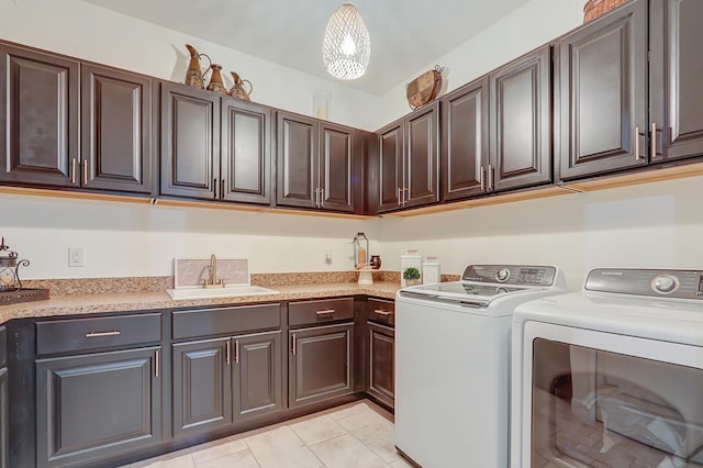 4052 SW Mccandless St, Port Saint Lucie, FL 34953 - laundry room with cabinet space, independent washer and dryer, and light tile patterned floors