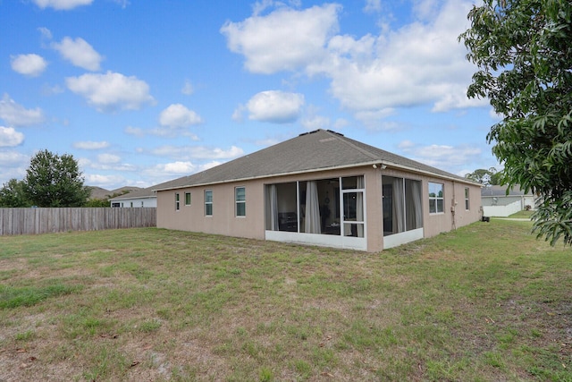 4052 SW Mccandless St, Port Saint Lucie, FL 34953 - rear view of house with a sunroom and stucco siding