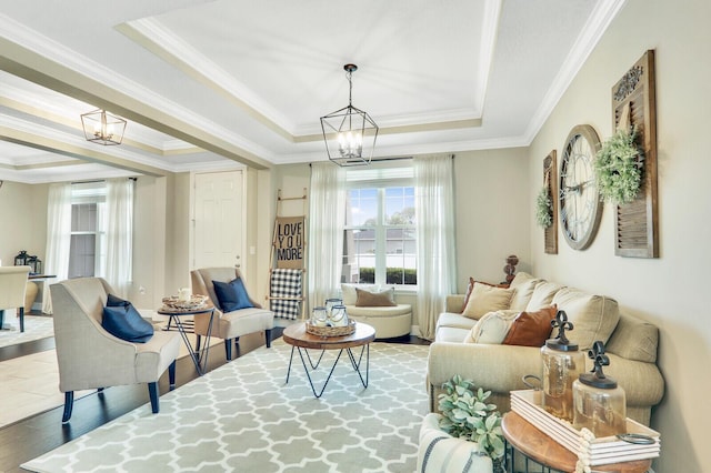 4052 SW Mccandless St, Port Saint Lucie, FL 34953 - living area featuring a chandelier, a raised ceiling, ornamental molding, and wood finished floors