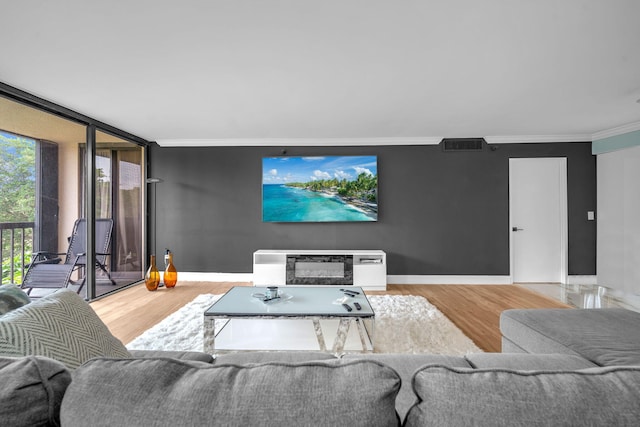 2480 Presidential Way Unit 303, West Palm Beach, FL 33401 - living area with wood finished floors, ornamental molding, baseboards, and a wall of windows