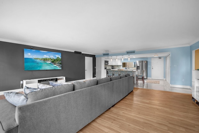 2480 Presidential Way Unit 303, West Palm Beach, FL 33401 - living room with ornamental molding, light wood finished floors, and baseboards