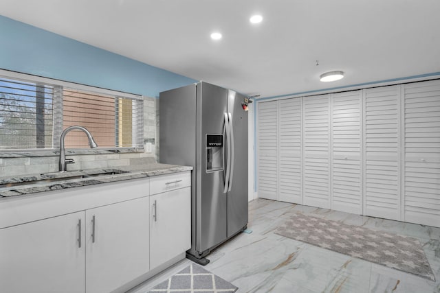 2480 Presidential Way Unit 303, West Palm Beach, FL 33401 - kitchen with stainless steel fridge, a sink, white cabinetry, light marble finish flooring, and recessed lighting