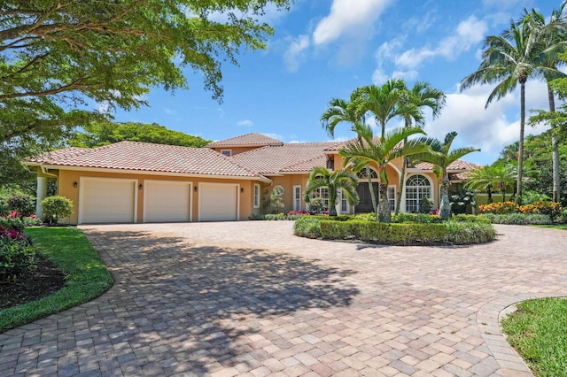 8380 Woodsmuir Dr, West Palm Beach, FL 33412 - mediterranean / spanish-style house with stucco siding, a tile roof, and an attached garage
