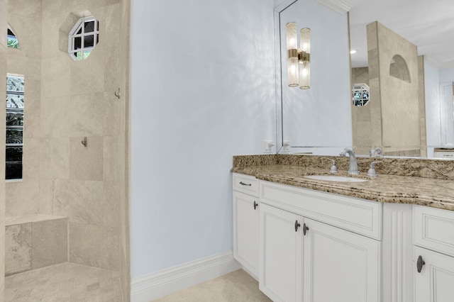 8380 Woodsmuir Dr, West Palm Beach, FL 33412 - full bathroom with tiled shower, vanity, baseboards, and tile patterned floors