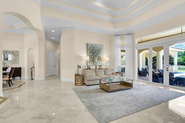 8380 Woodsmuir Dr, West Palm Beach, FL 33412 - living room featuring a high ceiling, crown molding, arched walkways, marble tiled flooring, and baseboards