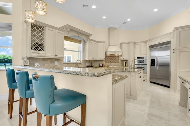 8380 Woodsmuir Dr, West Palm Beach, FL 33412 - kitchen featuring stainless steel appliances, crown molding, a kitchen breakfast bar, decorative backsplash, and light stone counters